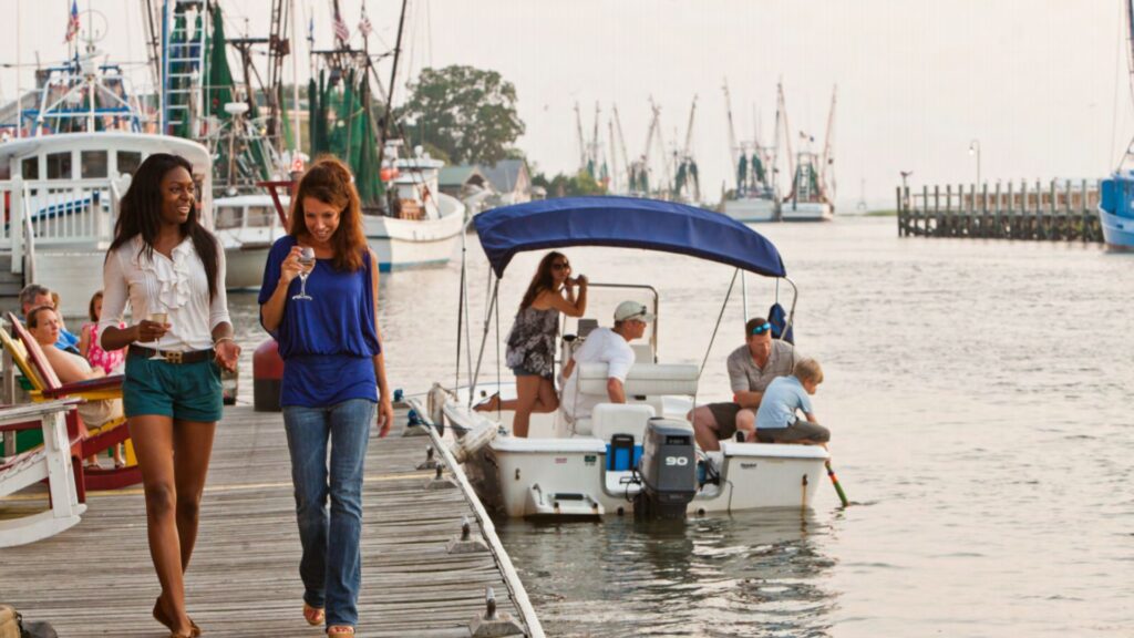 2 women walking on a dock at Shem Creek