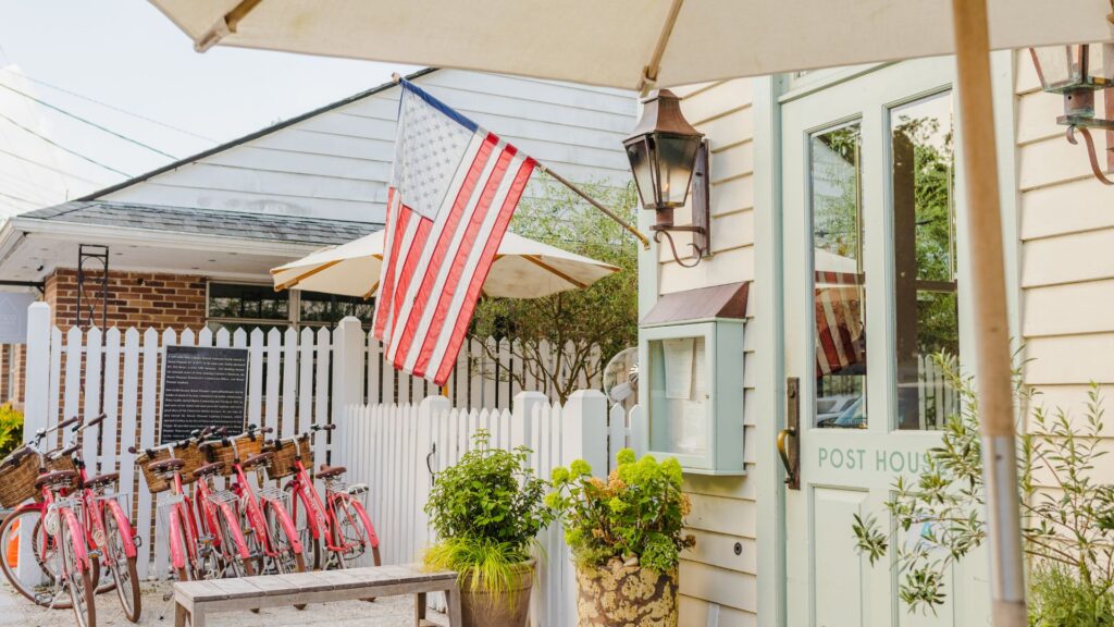 An American Flag hanging outside a building in the old village 