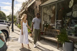 A couple holding hands and window shopping